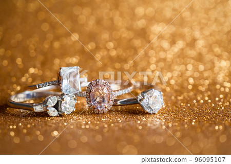 Jewelry diamond ring with abstract festive glitter Christmas holiday texture background blur with bokeh light 96095107