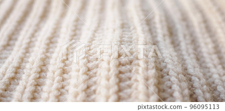closeup beige knitted woolen fabric texture background closeup beige knitted woolen fabric texture background 96095113