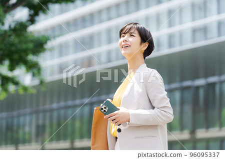 A woman standing in a business district A woman standing in a business district 96095337