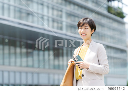 A woman standing in a business district A woman standing in a business district 96095342