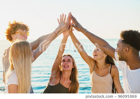 Group of friends having fun on the beach Group of friends having fun on the beach 96095869