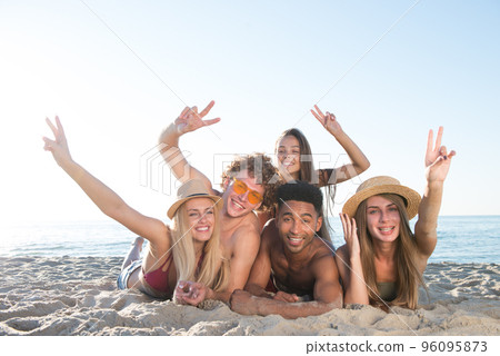 Group of friends having fun on the beach Group of friends having fun on the beach 96095873