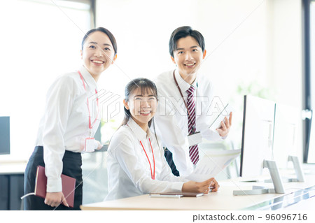 Young men and women having a meeting at the desk Young men and women having a meeting at the desk 96096716