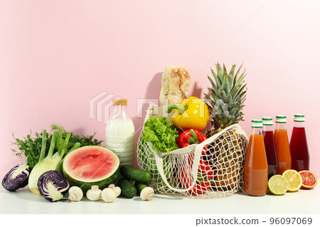 Grocery on white table against pink background Grocery on white table against pink background 96097069