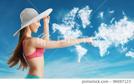 Tourist woman in bikini points at horizon in search of new travel route 96097123