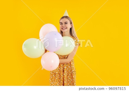 Concept of Happy Birthday with attractive girl on yellow background 96097815