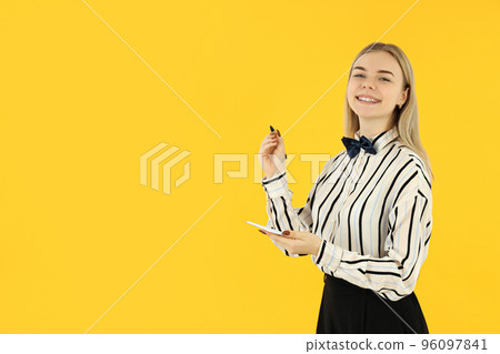 Concept of occupation, young female waiter on yellow background 96097841