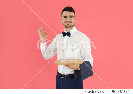 Concept of occupation, young waiter on pink background 96097855