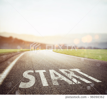 Start written to the ground on a road at sunset 96098362
