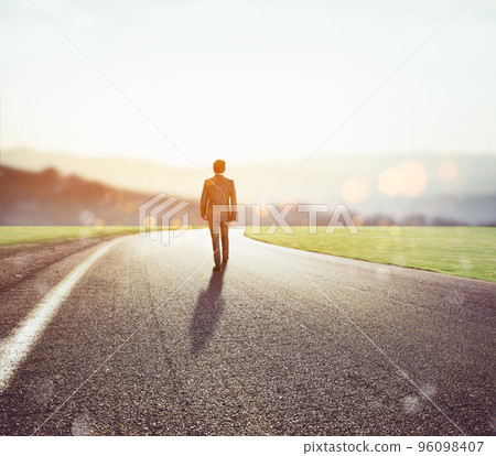 Man walks on an unknown road for a new adventure 96098407