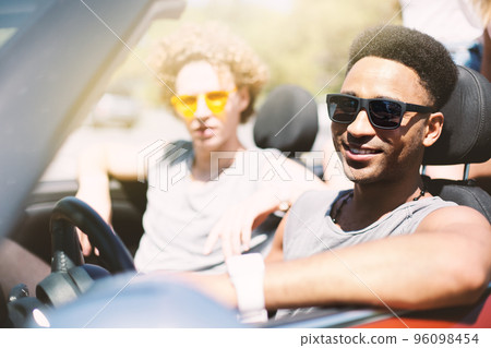 Young friends in cabriolet car ready to vacation 96098454
