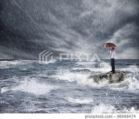 Businessman with umbrella during storm in the sea. Concept of crisis 96098474