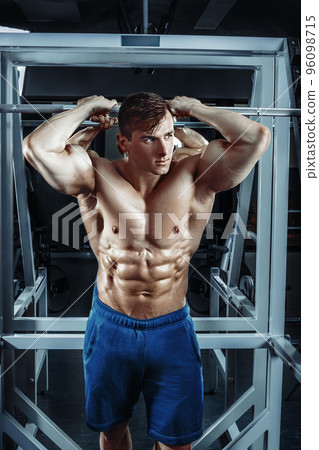 Male bodybuilder, fitness model trains in the gym Male bodybuilder, fitness model trains in the gym 96098715