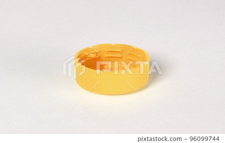 Isolated yellow plastic cap - Concept of pollution 96099744