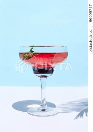 Fresh summer strawberry cocktail or mocktail on blue patel background. Creative drink beverage on sunlight with shadows Fresh summer strawberry cocktail or mocktail on blue patel background. Creative drink beverage on sunlight with shadows 96099757