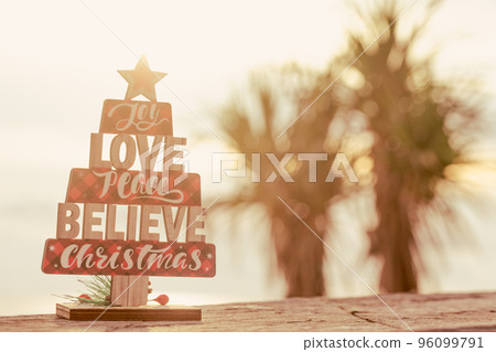 Christmas wooden toy tree on palms background. Christmas wooden toy tree on palms background. 96099791