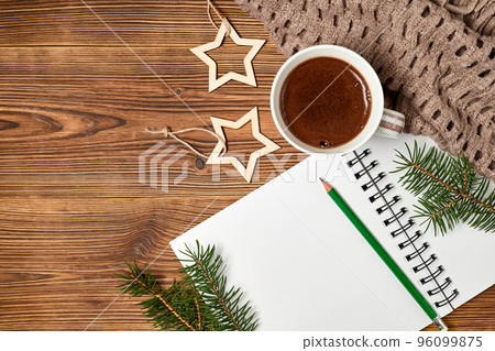 Christmas composition of open blank notepad, coffee cup, scarf and fir branches on wooden background 96099875