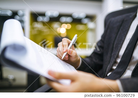 A man signs a contrac, legal or business agreements. Male hand with pen makes notes. A man signs a contrac, legal or business agreements. Male hand with pen makes notes. 96100729
