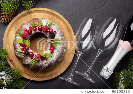 Christmas cake with pomegranate seeds, cranberries and rosemary 96100810
