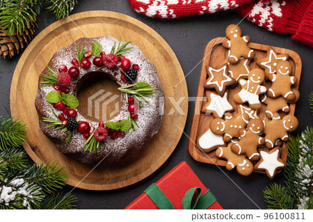 Christmas cake with pomegranate seeds, cranberries and rosemary 96100811