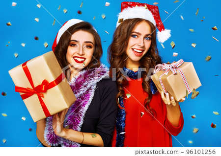 nice portrait of two happy young women in santa claus hat with gift .Christmas concept. 96101256