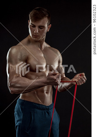 Young bodybuilder man on black background 96102323
