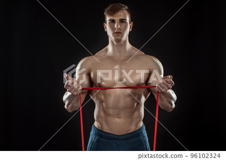 Young bodybuilder man on black background Young bodybuilder man on black background 96102324