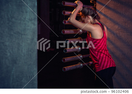 Young beautiful woman posing in a gym outfit. Young beautiful woman posing in a gym outfit. 96102406