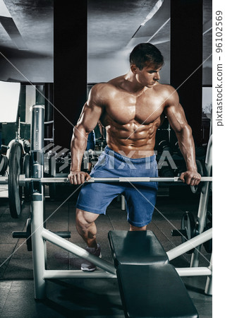Male bodybuilder, fitness model trains in the gym 96102569