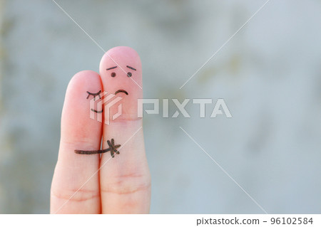 Fingers art of displeased couple. Man is sad, woman reassures her. She kisses and hugs hes. 96102584