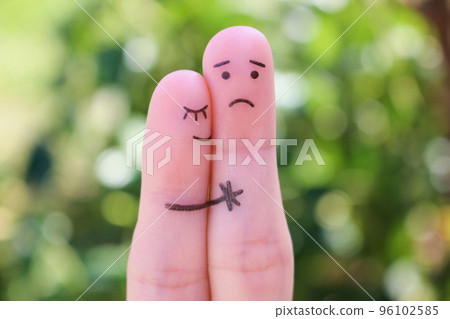 Fingers art of displeased couple. Man is sad, woman reassures her. She kisses and hugs hes. 96102585
