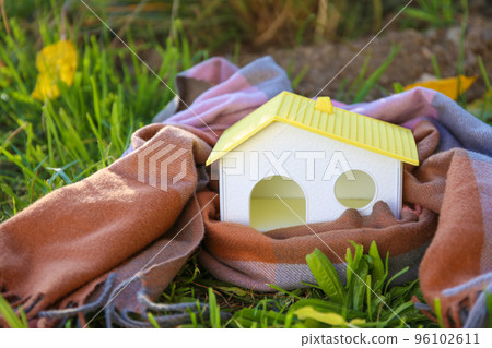 There is a woolen scarf around the house. The concept of alternative heating. There is a woolen scarf around the house. The concept of alternative heating. 96102611
