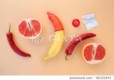 Fruits and vegetables, condoms on beige background. Concept of sex education. Flat lay. Top view. 96102645