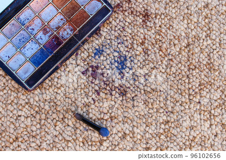 Eye shadow fell and scattered on carpet. Top view. Eye shadow fell and scattered on carpet. Top view. 96102656