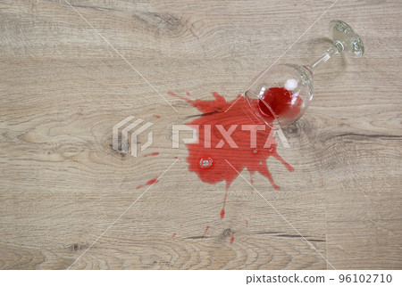 Glass of red wine fell on laminate, wine spilled on floor. Glass of red wine fell on laminate, wine spilled on floor. 96102710