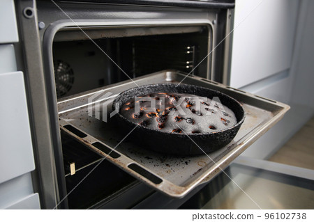 Burnt pie in the oven. 96102738