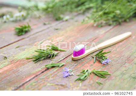 Herbed toothpaste with rosemary on an old wooden background. 96102745