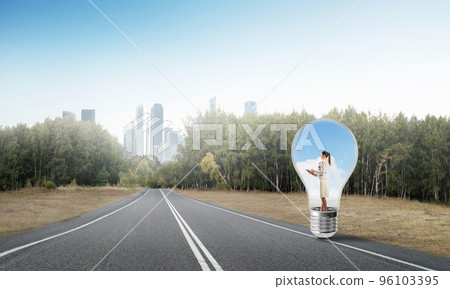 Businesswoman inside light bulb 96103395