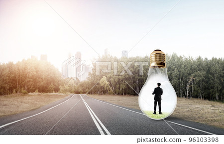 Businessman inside light bulb 96103398