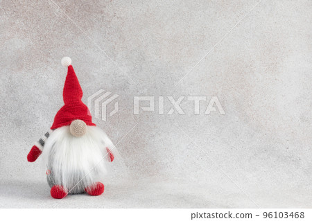 Christmas handmade gnome in red hat holiday banner on light winter background Christmas handmade gnome in red hat holiday banner on light winter background 96103468