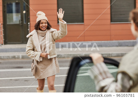 Girl meeting her friend outside 96103781