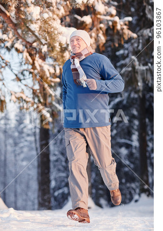 Senior Man Running in Winter Forest Senior Man Running in Winter Forest 96103867
