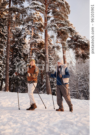 Sporty Senior Couple Walking in Winter Forest Sporty Senior Couple Walking in Winter Forest 96103901