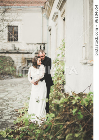 Sensual married couple, valentines hugging in front of old slavic castle Sensual married couple, valentines hugging in front of old slavic castle 96104054