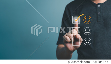 Customer service and Satisfaction concept ,Business people are touching the virtual screen on the happy smiley face icon to give satisfaction in service. rating very impressed.. 96104133