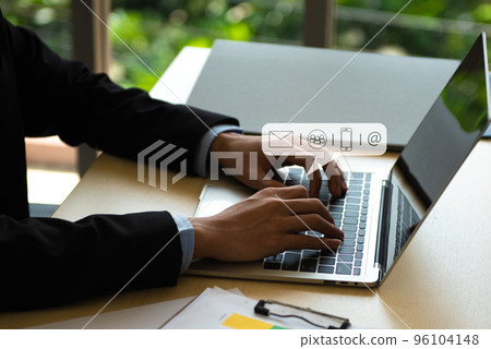 Business Contact Us concept, Hands typing on keyboard computer with communication contact icon, E-mail, Phone number, Social media chatting message. Business Contact Us concept, Hands typing on keyboard computer with communication contact icon, E-mail, Phone number, Social media chatting message. 96104148