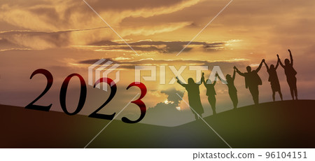 Happy new year 2023, Keep fighting together, Silhouette of 2023 letters on the mountain with business people raised arms in teamwork concept at sunrise.. Happy new year 2023, Keep fighting together, Silhouette of 2023 letters on the mountain with business people raised arms in teamwork concept at sunrise.. 96104151