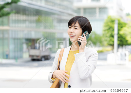 Woman calling outdoors Woman calling outdoors 96104937