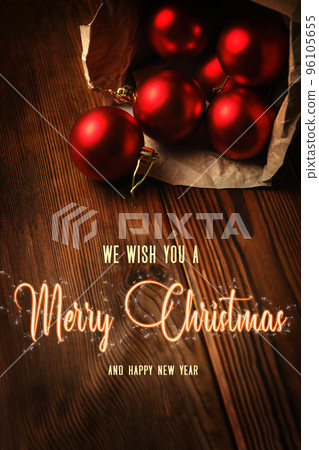 Red christmas balls in a box on a wooden table 96105655