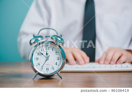 Business people working times concept, Businessman working and  typing on laptop computer  with  clock on the desk. 96106419